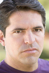 Head shot of man scowling