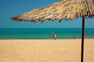 Fototapeta na wymiar Beach with golden sands and blue sea water