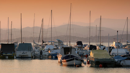 Sailboats in port of Le Brusc, French riviera, at sunset