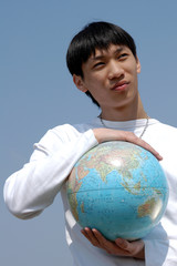 Young Asian Man with a Globe