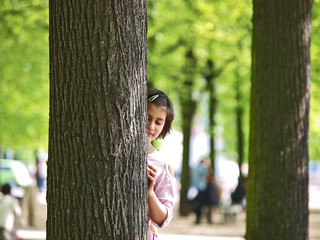 sch&ouml;nes m&auml;dchen hinter dem baum