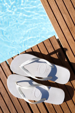 White Flipflops By Pool Side