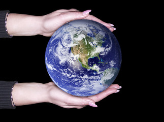 Hands holding a glowing Earth