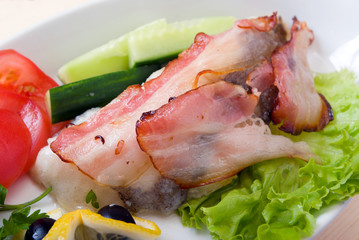 The halibut prepared with vegetables and bacon