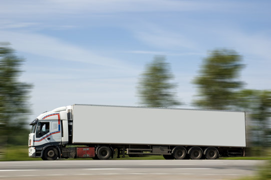A heavy truck hurries to deliver a load on purpose.