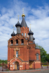 Fototapeta na wymiar Red Church with black cupolas