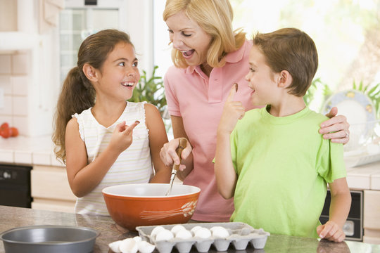 Woman And Two Children Baking And Smiling