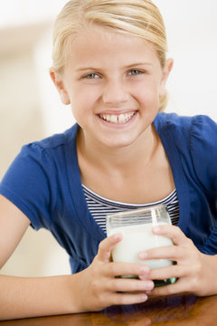 Young girl drinking milk smiling