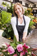 Peel and stick wall murals Flower shop Woman working at flower shop smiling