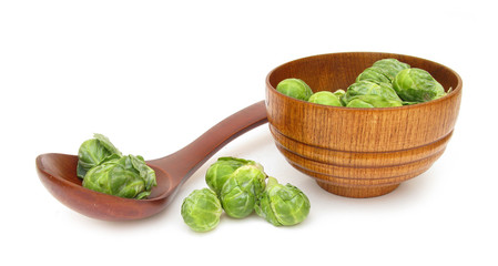 Brussels sprout in wooden spoon and dish