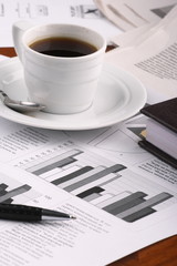 Cup of fragrant coffee on a morning paper business news