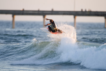 Surfer flying in the air on a wave