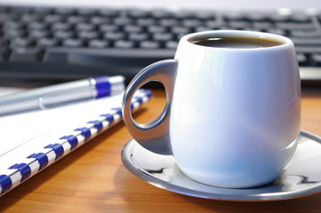 Cup of coffee and notebook