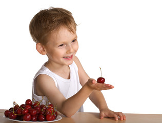 Little boy with a plate of a cherry