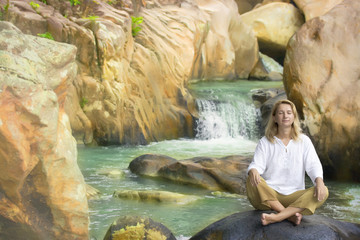 Fototapeta na wymiar Young woman on waterfall background