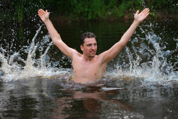 Young man jumps from the water