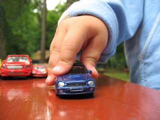 Little boy play with toy-car, detail hand and toy