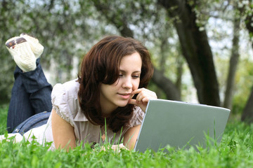 The girl with laptop on the nature