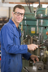 Machinist working on machine