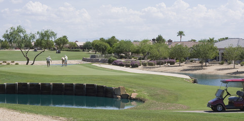Seniors playing golf in the desert