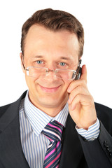 businessman in glasses speaks on cell phone