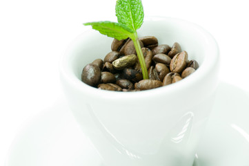 A cup of coffee full of coffee beans