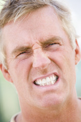 Head shot of man scowling