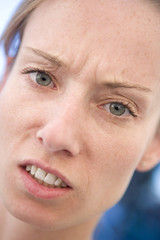 Head shot of woman scowling