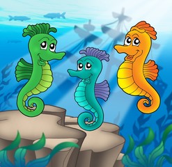 Sea horses family with shipwreck