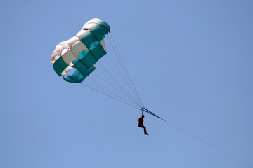Flying parachute on background with blue sky