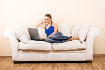 young woman on a lounge with a laptop