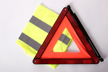 warning triangle and yellow waistcoat