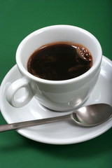 white coffee cup on green background