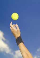 tennis player tossing up ball
