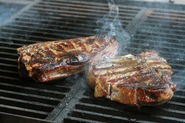 Steak cooking on flame grill