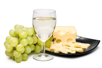 Wine in a glass, grapes and cheese