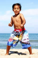 Fototapeta na wymiar Child Having Fun at the Beach