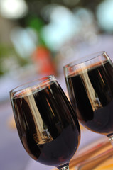 two glasses in outside restaurant with black wine