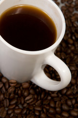 Cup with coffee, costing on coffee grain