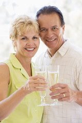 Couple toasting champagne and smiling