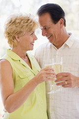 Couple toasting champagne and smiling