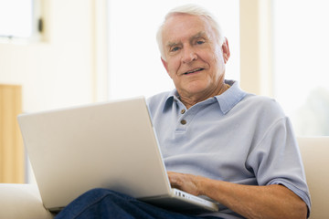 senior,man,laptop,computer,at home,sofa,browsing,surfing,interne