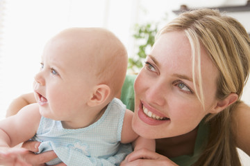 Mother in living room with baby smiling