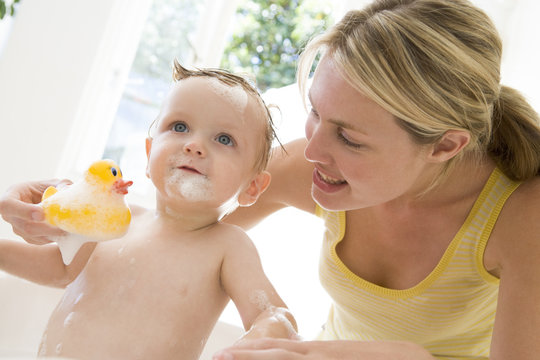 Mother Giving Baby Bubble Bath Smiling