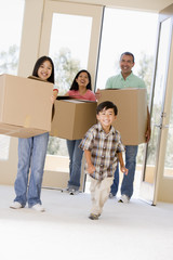 Family with boxes moving into new home