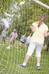 Five young friends playing soccer