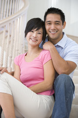 Fototapeta premium Couple sitting on staircase smiling