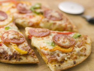 Pepperoni and Pepper Pizza with a Pizza Cutter