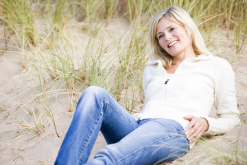 Woman lying on beach smiling