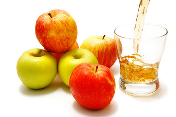 apples over white with filled glass